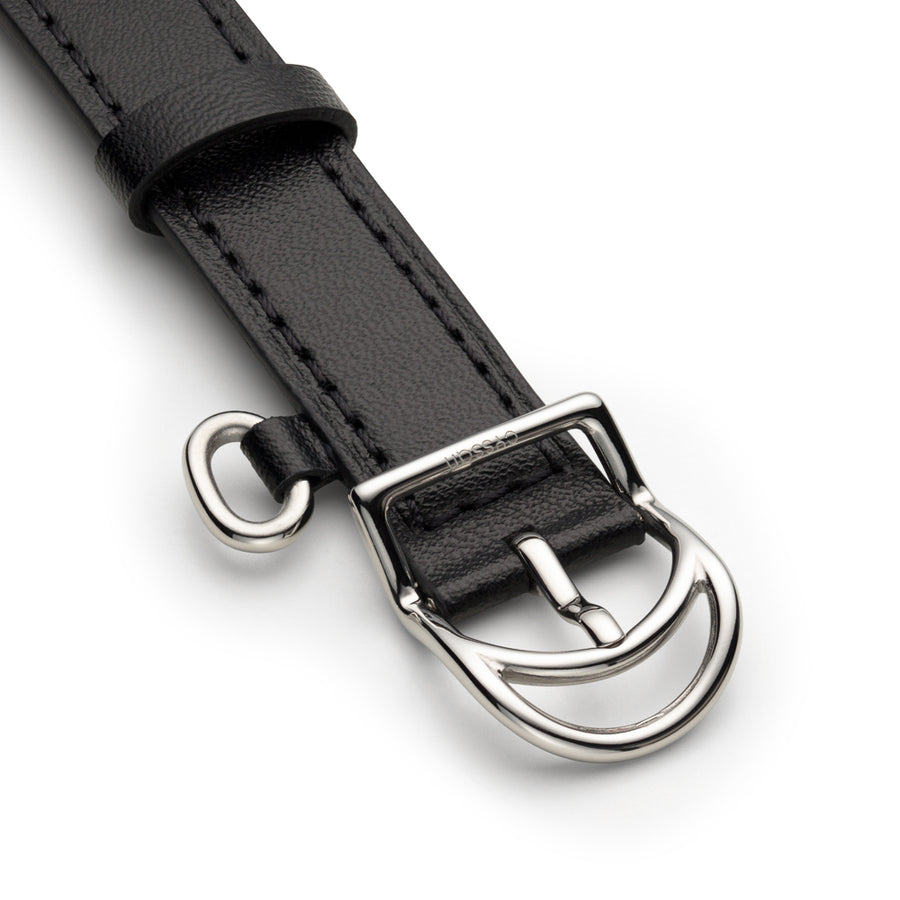 black vegan-leather strap with silver buckle and special metallic ring attached to strap.